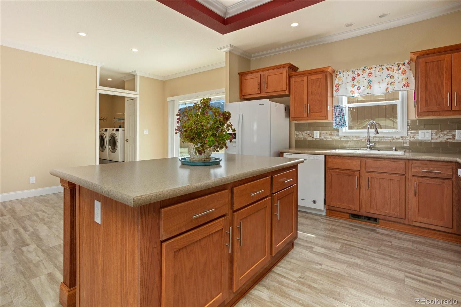 655 Quarry Station Poncha Springs, CO 81242 - Photo 6 of 41 a kitchen with stainless steel appliances granite countertop a sink dishwasher a stove and a refrigerator with wooden cabinets