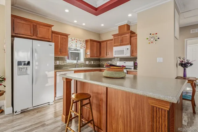 a kitchen with stainless steel appliances granite countertop a refrigerator and a sink