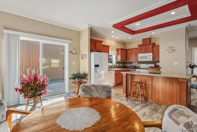 a living room with kitchen island furniture and a chandelier