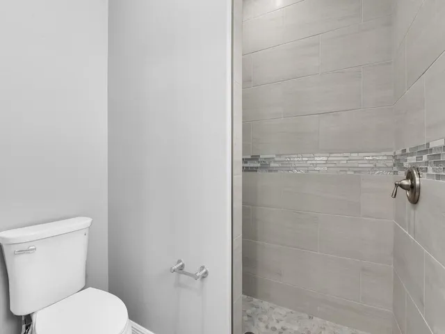 a bathroom with a toilet and shower