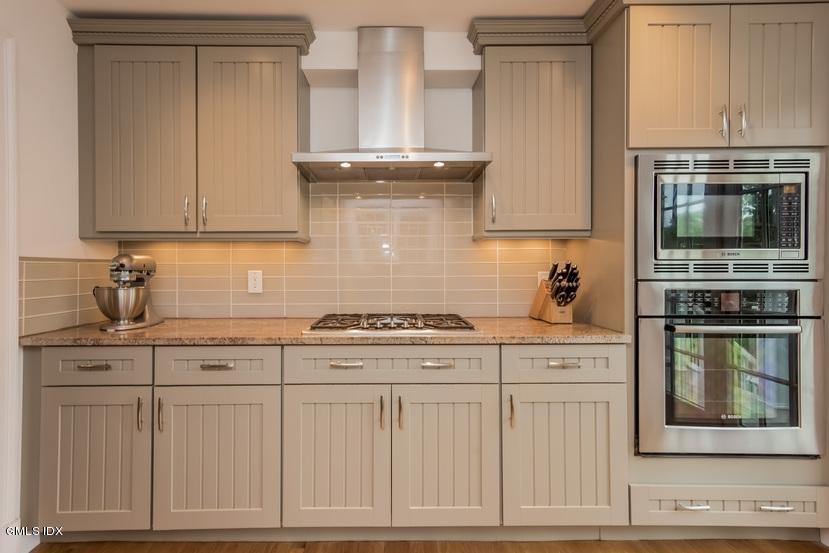 15 Pierce Road Riverside, CT 06878 - Photo 8 of 23 a kitchen with white cabinets and appliances