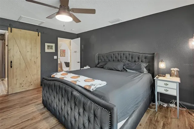 a bedroom with a bed and a chandelier