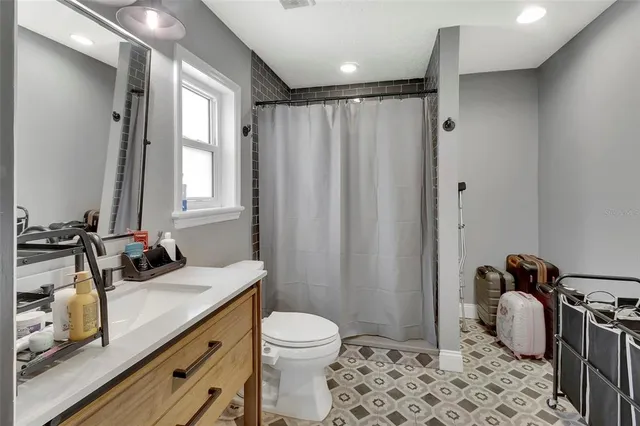 a bathroom with a sink toilet and shower