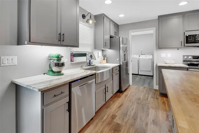 a kitchen with granite countertop a sink stove and cabinets