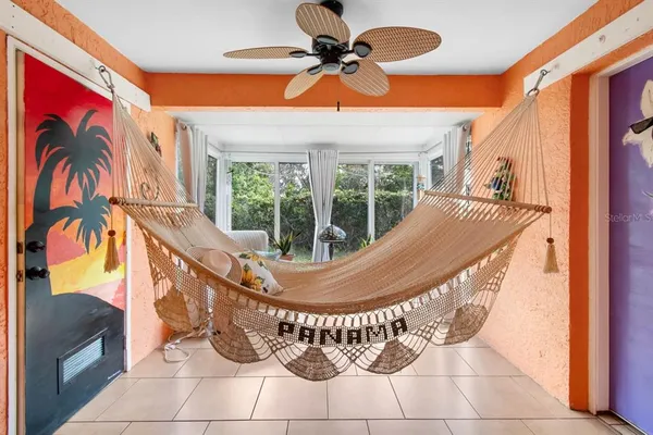 a bedroom with a bed and a flat tv screen on dresser
