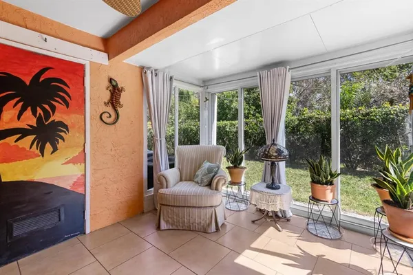 a vase of flowers sitting in front of a house