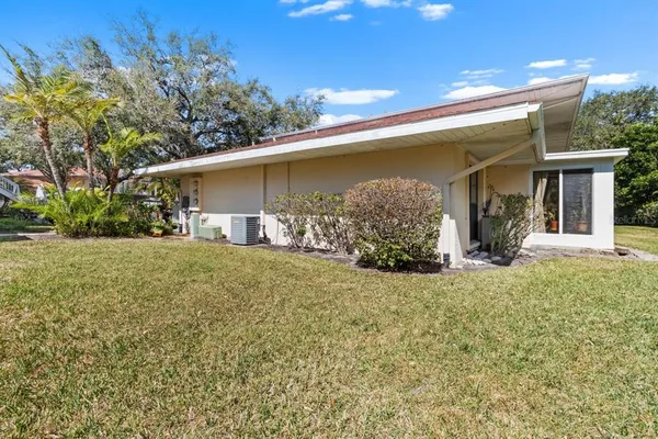 an aerial view of a house with a yard basket ball court and outdoor seating