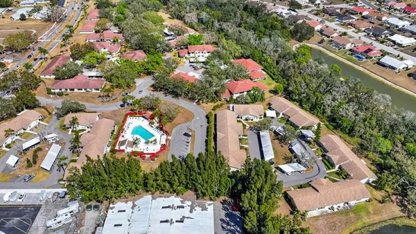 an aerial view of a house with a yard and garden