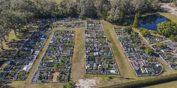 an aerial view of a house with a yard and furniture