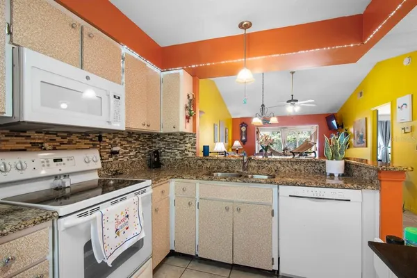 a view of a dining room with furniture and chandelier
