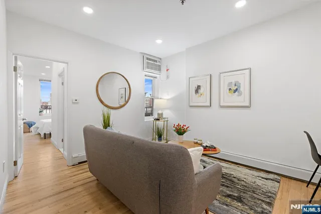 a living room with furniture and a mirror