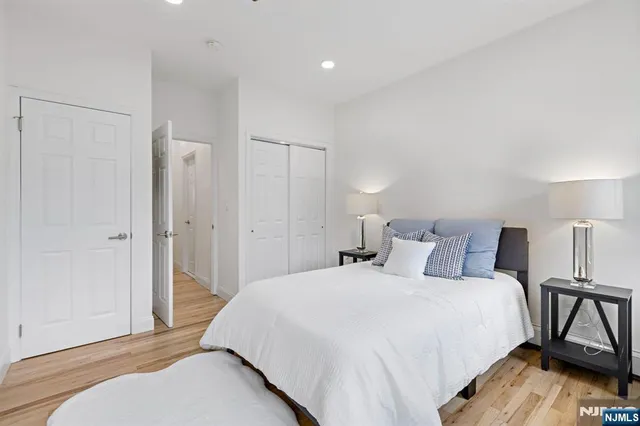 a bedroom with a bed and wooden floor