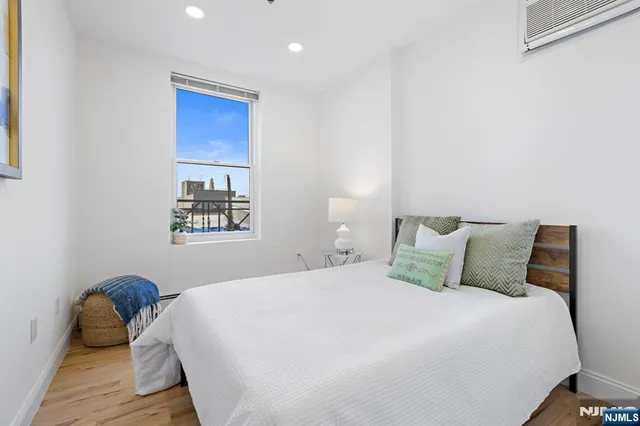 a bedroom with a bed and a painting