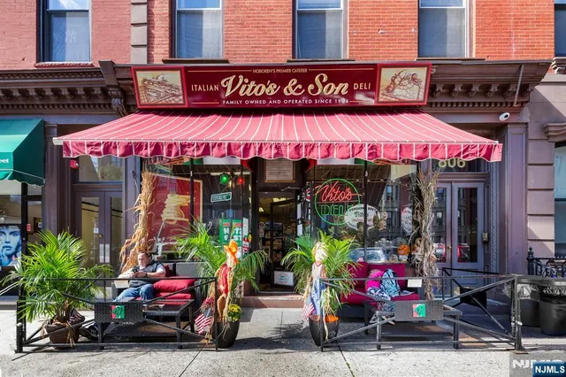 a view of a patio with table and chairs under an umbrella