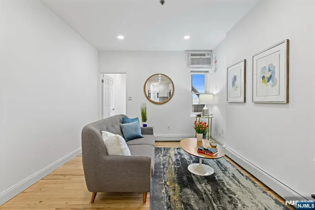 a living room with furniture and a clock