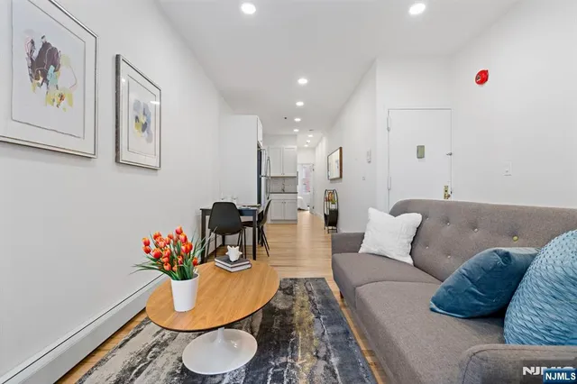 a living room with furniture and flowers