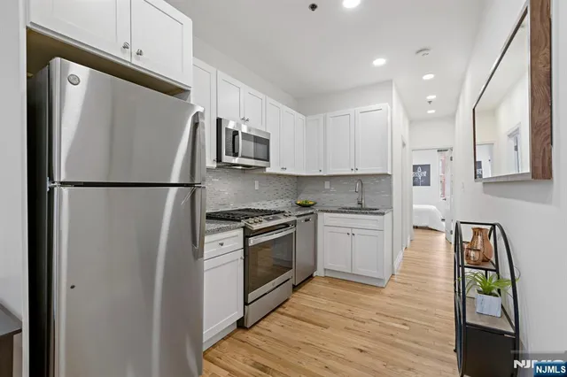 a white refrigerator freezer sitting inside of a kitchen