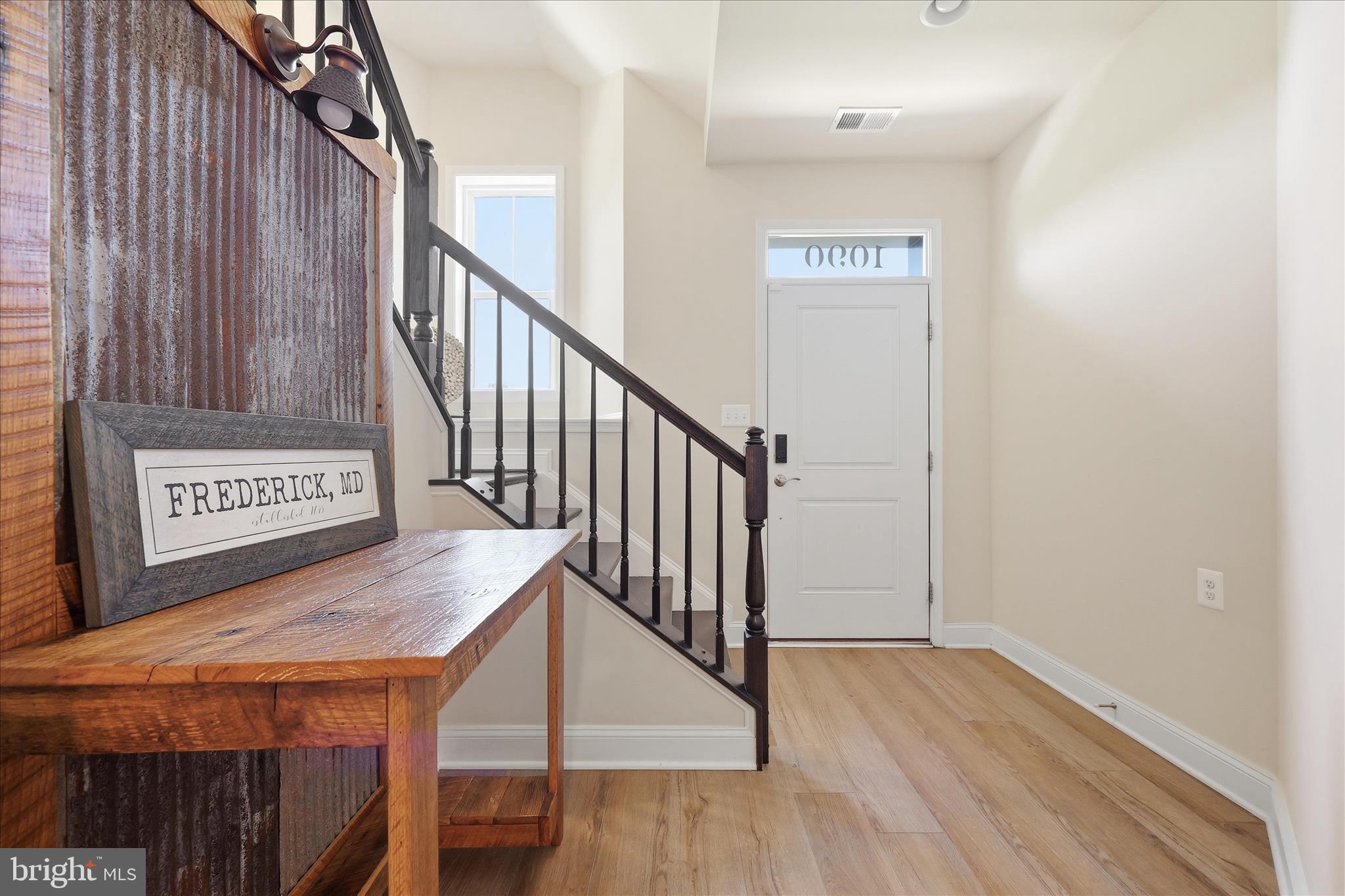 1090 Holden Road Frederick, MD 21701 - Photo 3 of 60 a view of a hallway with wooden floor and stairs