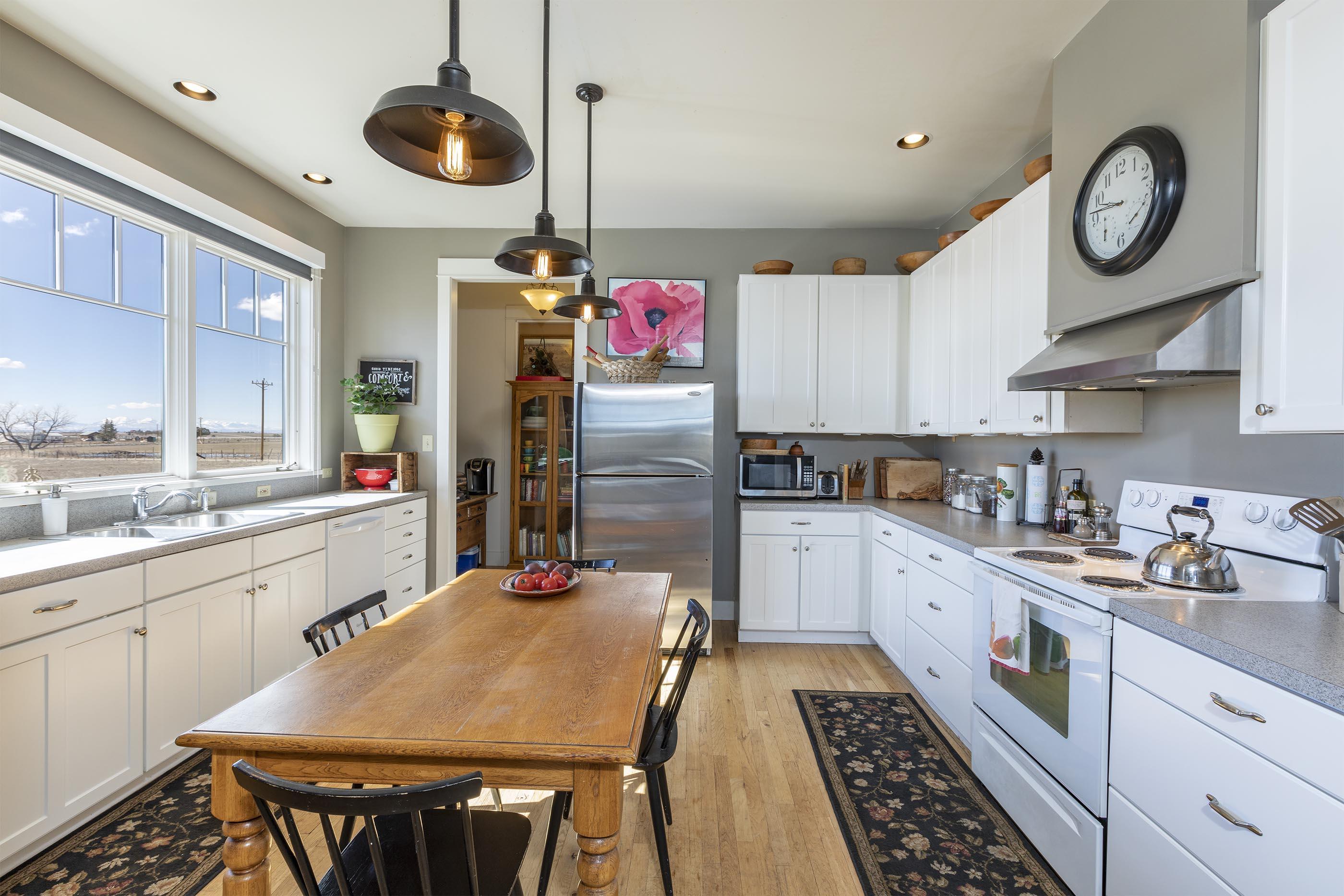 310 40aa Road Norwood, CO 81423 - Photo 7 of 35 a kitchen with stainless steel appliances granite countertop a stove a sink dishwasher and white cabinets with wooden floor