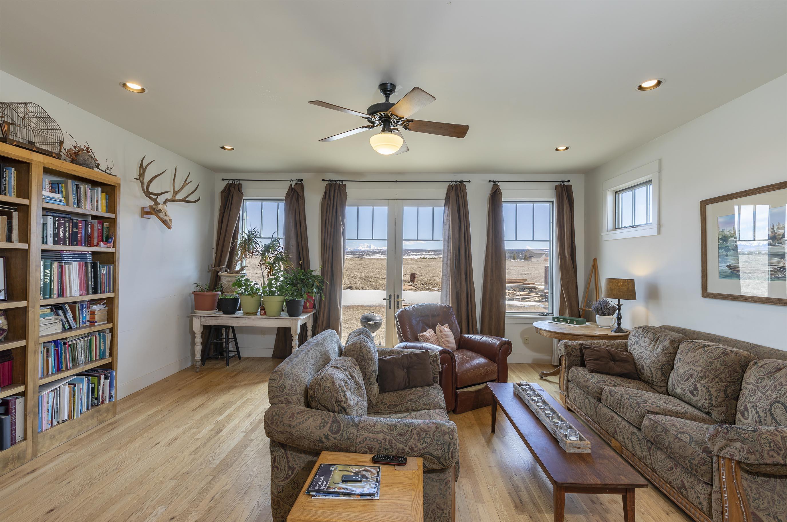 310 40aa Road Norwood, CO 81423 - Photo 8 of 35 a living room with furniture a bookshelf and a large window