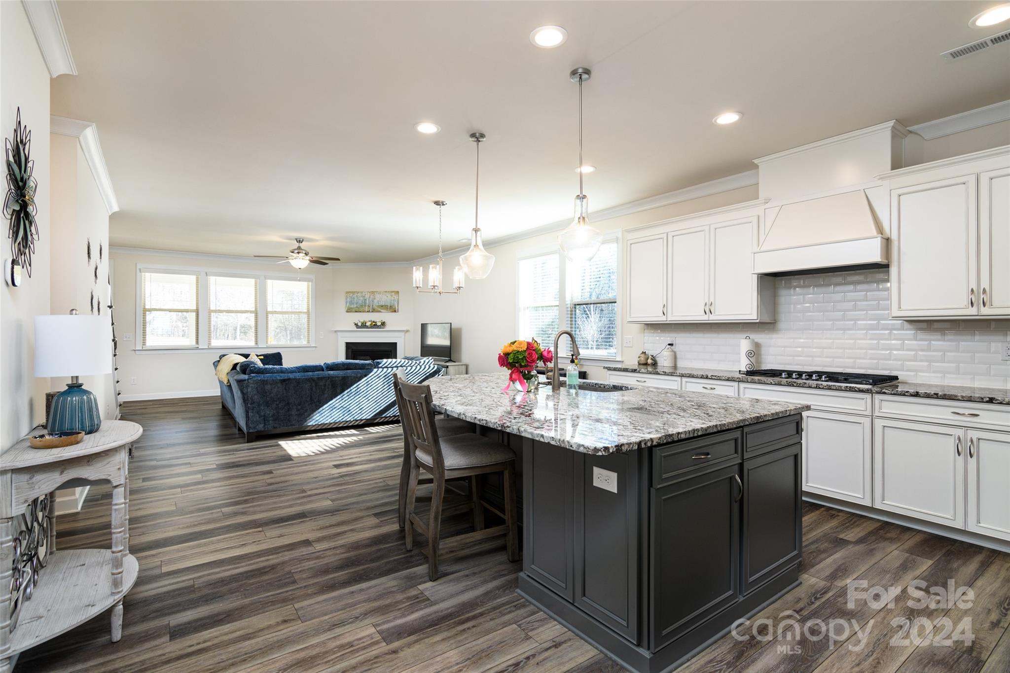1435 Liberty Row Drive Fort Mill, SC 29708 - Photo 7 of 34 a open kitchen with stainless steel appliances granite countertop a table chairs sink and cabinets