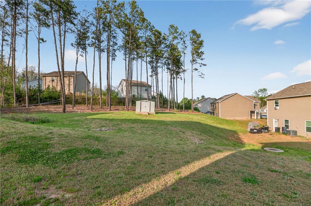 1003 Nandina Court Villa Rica, GA 30180 - Photo 22 of 43 a front view of a house with garden and trees