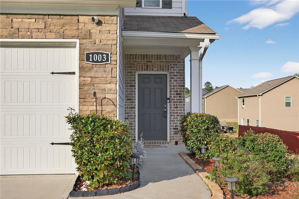 1003 Nandina Court Villa Rica, GA 30180 - Photo 3 of 43 a front view of a house with garden