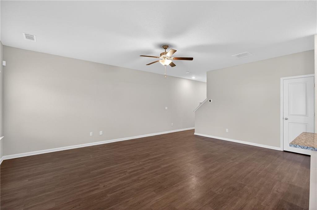 1003 Nandina Court Villa Rica, GA 30180 - Photo 5 of 43 a view of a room with wooden floor and a ceiling fan