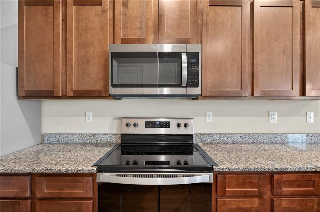 1003 Nandina Court Villa Rica, GA 30180 - Photo 8 of 43 a kitchen with granite countertop a stove and a sink