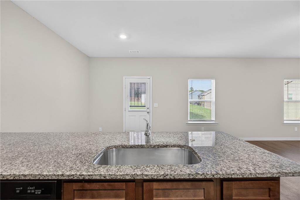 1003 Nandina Court Villa Rica, GA 30180 - Photo 9 of 43 a kitchen with granite countertop a sink a window and counter space