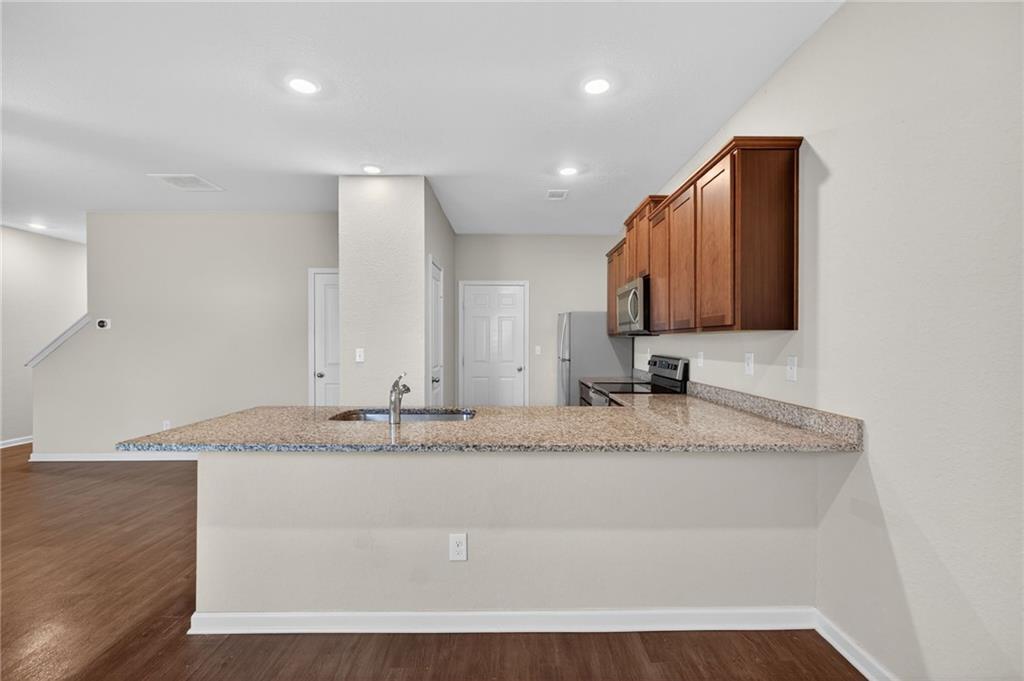 1003 Nandina Court Villa Rica, GA 30180 - Photo 10 of 43 a bathroom with a granite countertop sink and a mirror