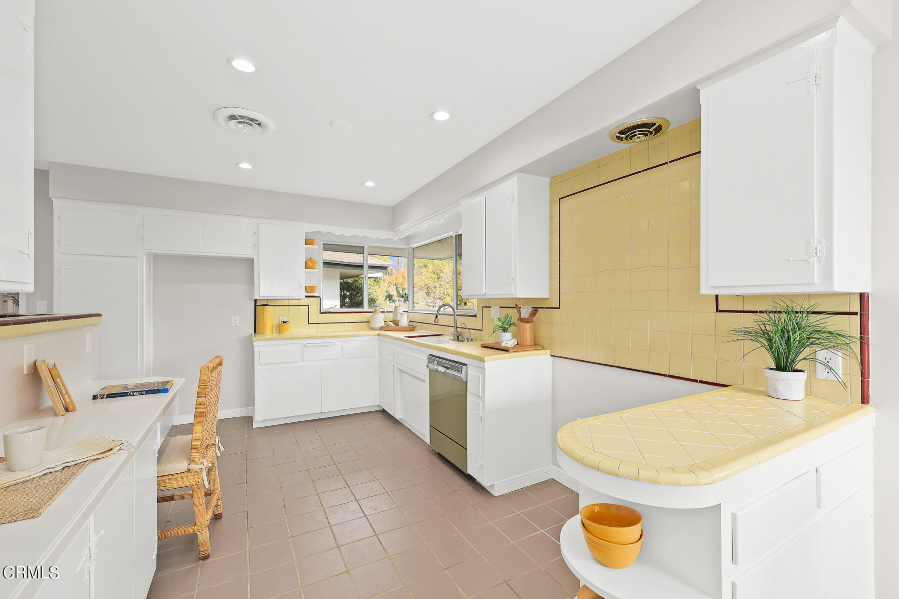 515 Cliff Drive Pasadena, CA 91107 - Photo 12 of 37 a kitchen with a sink a stove a kitchen island and chairs