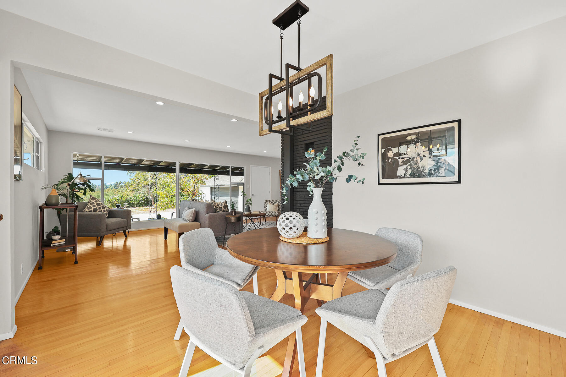 515 Cliff Drive Pasadena, CA 91107 - Photo 16 of 37 a dining room with wooden floor a chandelier a glass table and chairs