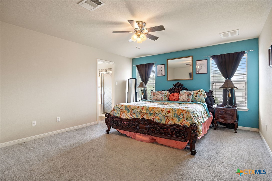 326 Comal Run Hutto, TX 78634 - Photo 15 of 23 a bed sitting in a bedroom next to a window