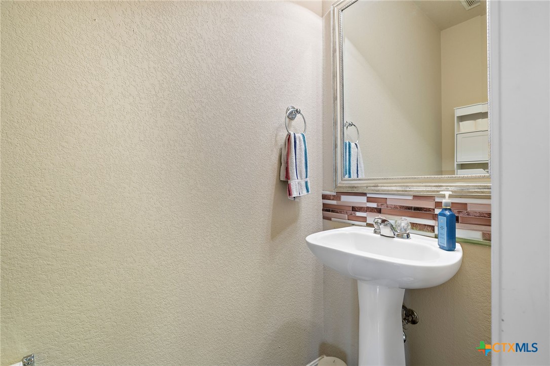 326 Comal Run Hutto, TX 78634 - Photo 16 of 23 a bathroom with a sink and a mirror