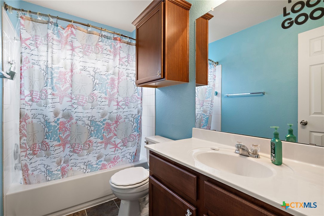 326 Comal Run Hutto, TX 78634 - Photo 17 of 23 a bathroom with a sink and a mirror