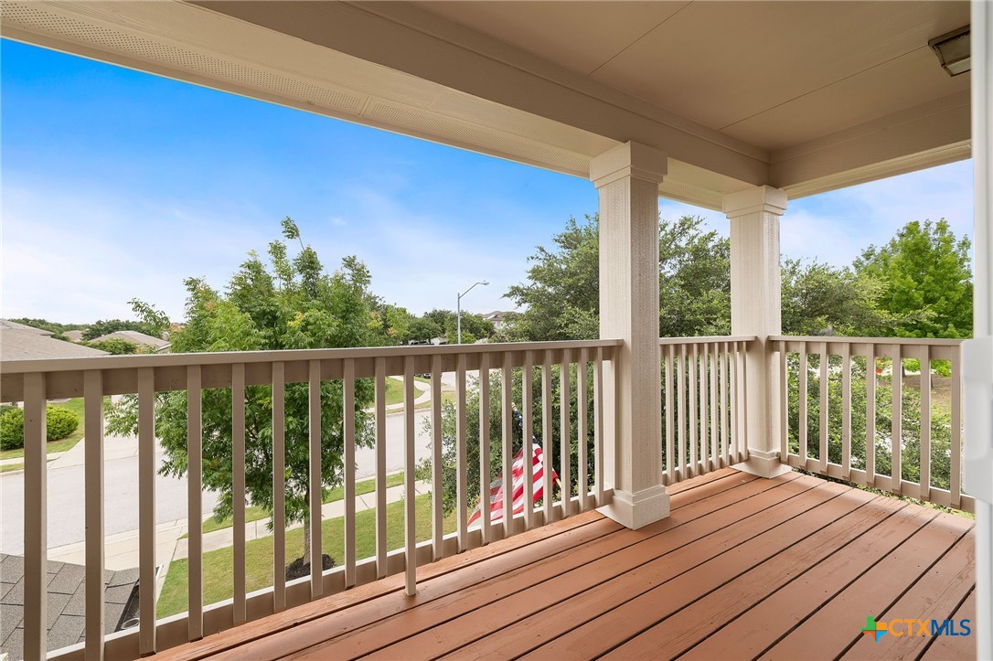 326 Comal Run Hutto, TX 78634 - Photo 21 of 23 a view of balcony with wooden floor & fence