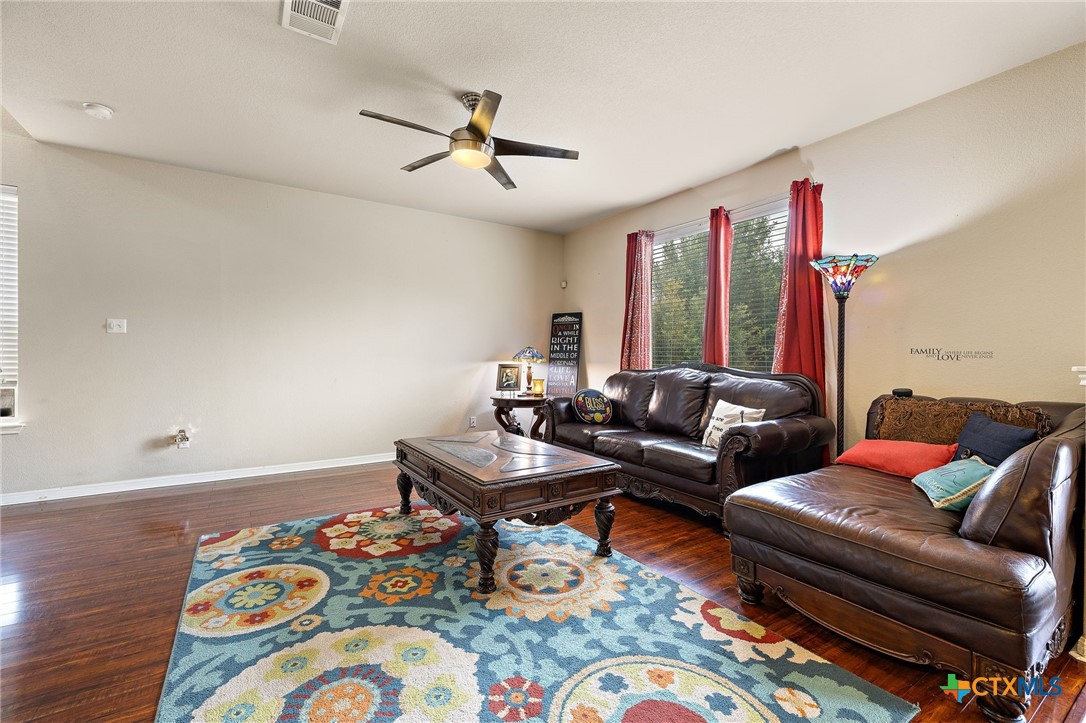 326 Comal Run Hutto, TX 78634 - Photo 9 of 23 a living room with furniture and wooden floor