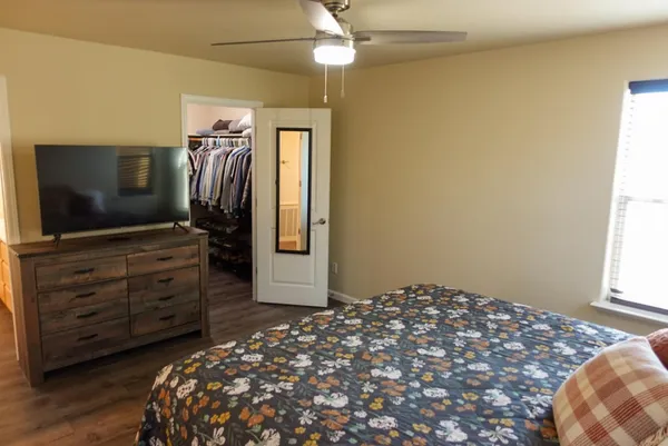 a bedroom with a bed and a flat screen tv