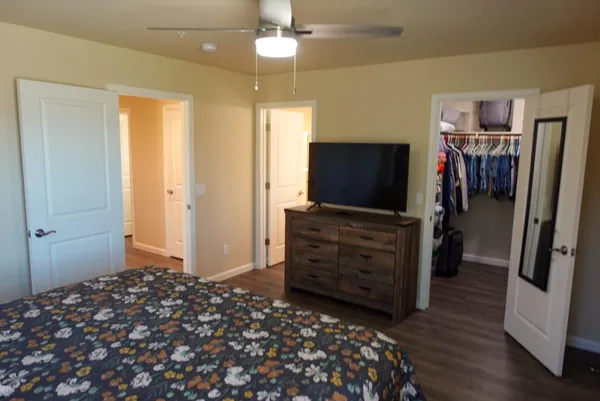 a bedroom with a bed and wooden floor