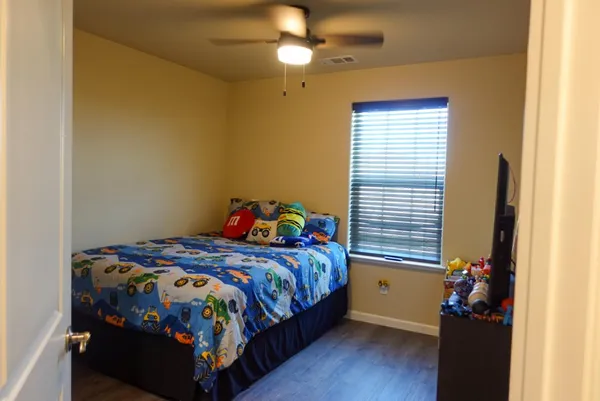 a bedroom with a bed and a window