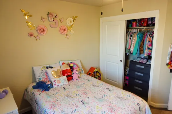 a bedroom with a bed and cabinets