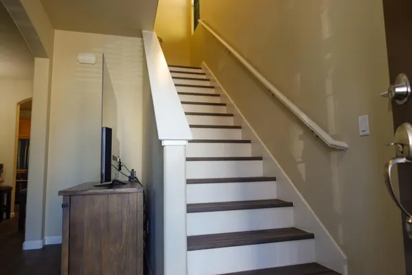 a view of entryway and hall with wooden floor