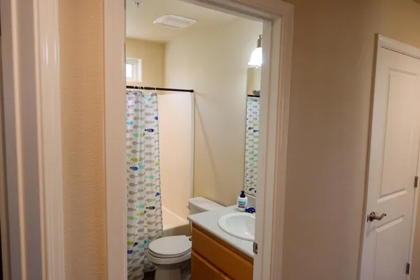 a bathroom with a granite countertop sink toilet and shower