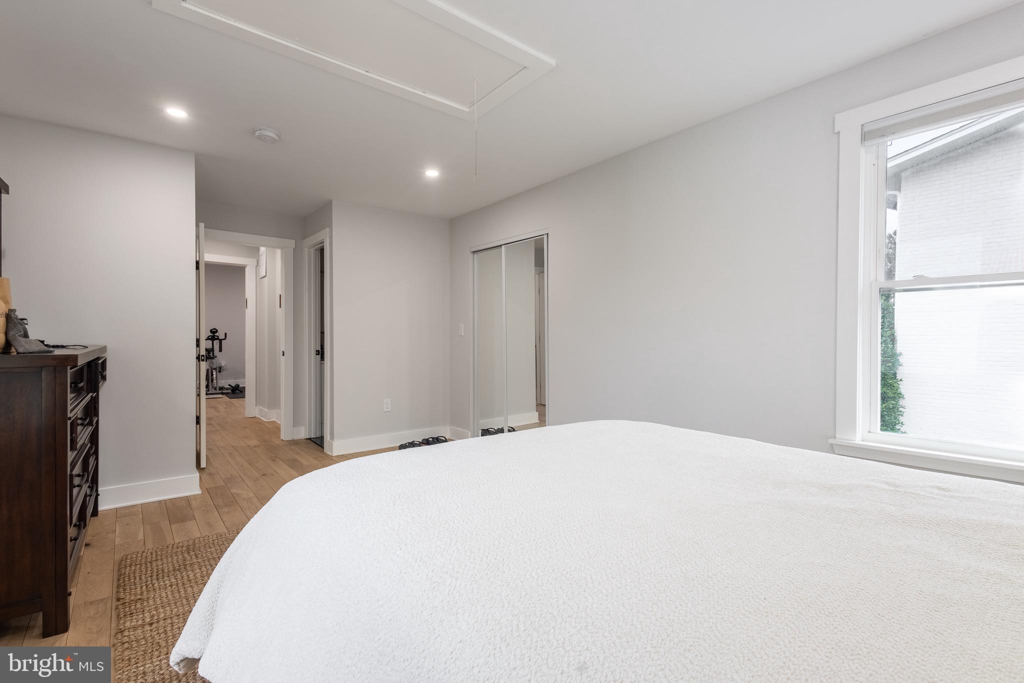 37 4th Street Laurel, MD 20707 - Photo 17 of 26 a spacious bedroom with a bed and a flat tv screen