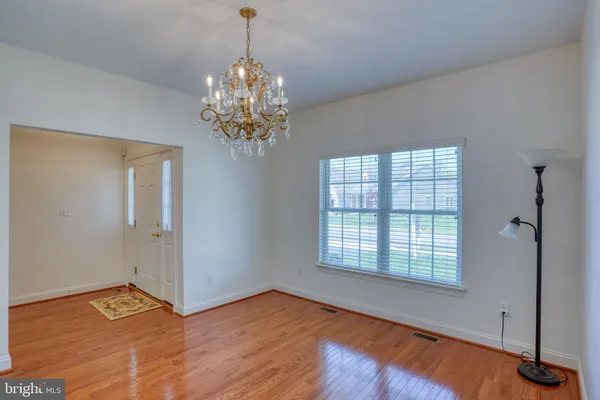 a view of a room with wooden floor and window