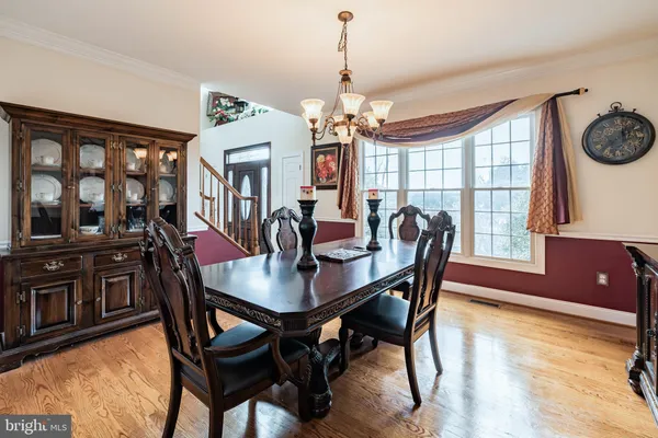 a view of a dining room with furniture kitchen and wooden floor