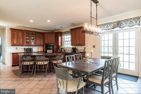 a kitchen with stainless steel appliances granite countertop a stove a sink dishwasher and a microwave oven with cabinets