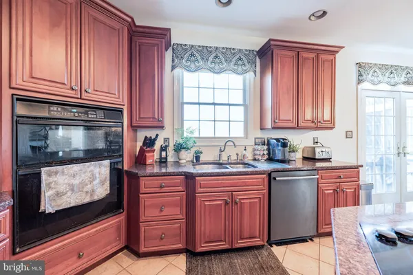 a kitchen with granite countertop a sink and cabinets