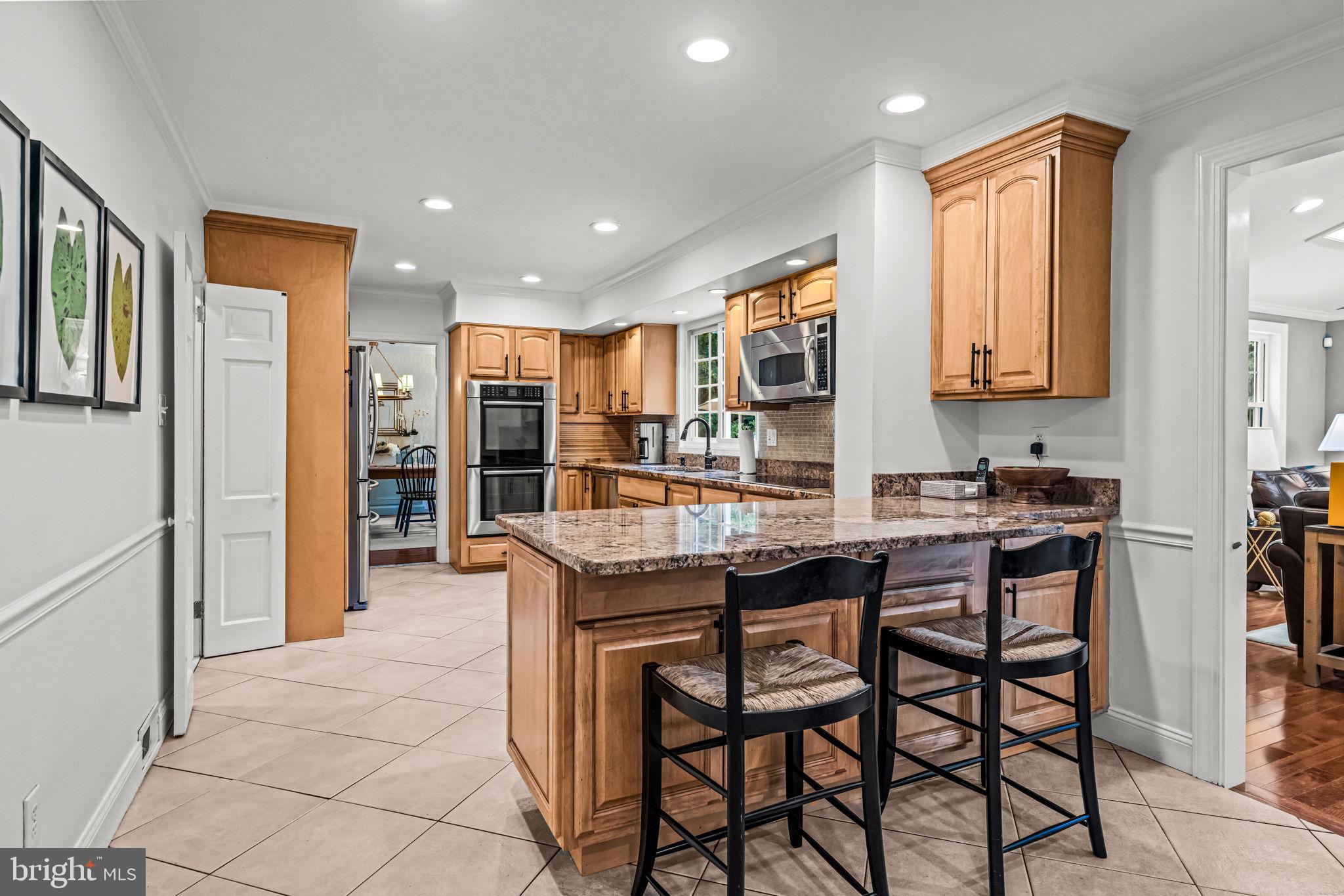 363 Colket Lane Wayne, PA 19087 - Photo 12 of 52 a kitchen with stainless steel appliances granite countertop a stove a sink and a refrigerator